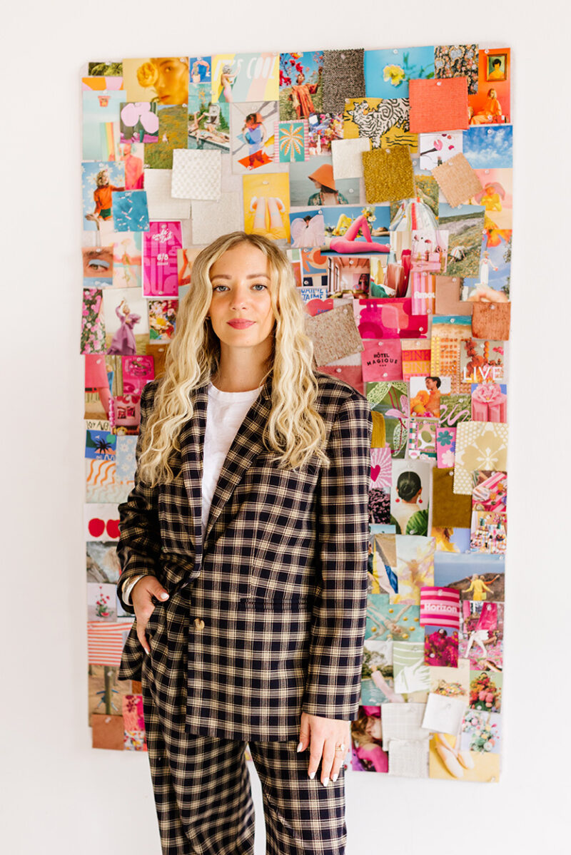 Editorial shoot of a woman in a suit with colorful mood board behind her being a girl boss by Jenna Bechtholt, Los Angeles wedding photographer
