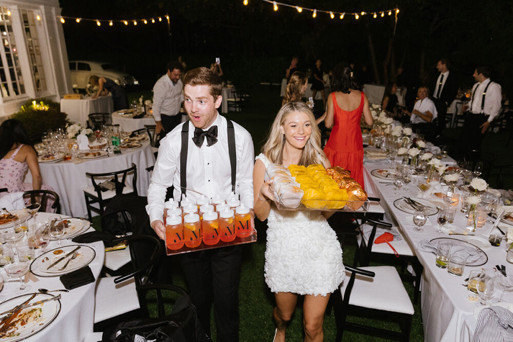 A couple presents late night snacks at their wedding reception in Seattle, photographed by a los angeles wedding photographer