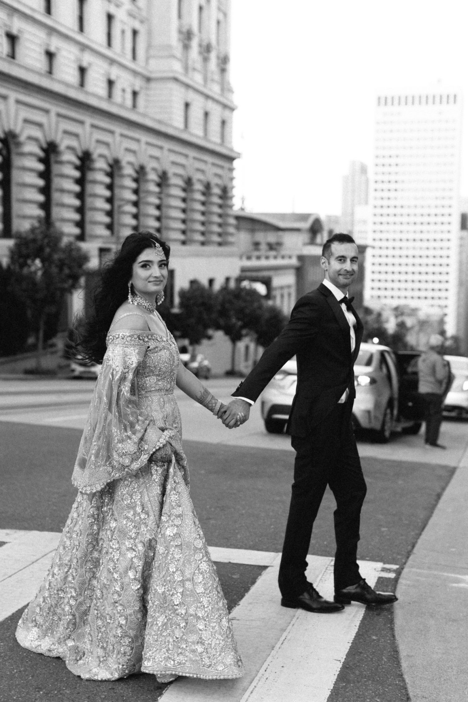 Urban Indian wedding couple crossing the street in front of the four seasons hotel in san francisco shot by a los angeles wedding photographer