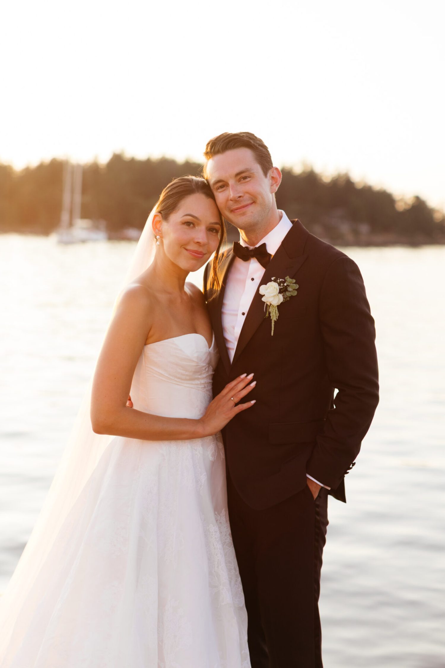 A married couple on the dock at Roche Harbor after just getting married during golden hour, photographed by a los angeles wedding photographer